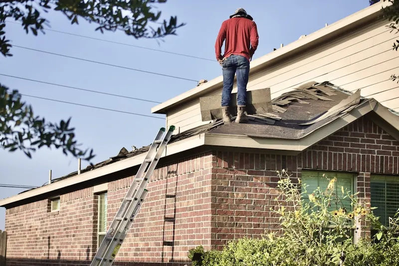 Professional roofer working on a residential roof in Meadow Brook
